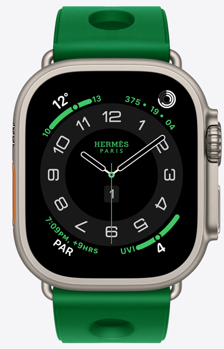 Apple Watch Hermès Ultra 4, Circulaire analogue watch face, (hour, minute and second hands, complications: Weather, Activity rings, Paris time and UV index), titanium case, natural colour, right side exterior, Digital Crown, raised side button, paired with Scub'H Diving band, Vert Vertigo colour (bright green), moulded rubber material, circular cutouts centred