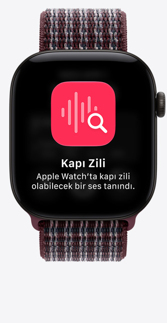 Apple Watch Series 12, ekranda kapı zilinin ses tanıma özelliği gösteriliyor, alüminyum kasa, siyah renk, Spor Loop kordona takılı, bordo kareli renk