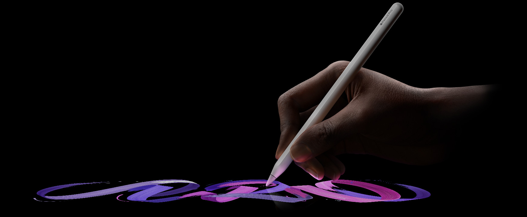 Korisnik drži Apple Pencil Pro i ostavlja živopisan trag linije kista
