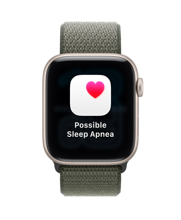 Apple Watch SE 3, алуминиев корпус, астро бял цвят, известие за възможна сънна апнея, розово сърце в бяла кутийка, външна дясна страна, Digital Crown, Sport Loop, горско зелен цвят